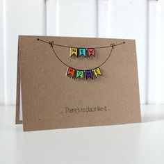 a card with the words happy birthday hanging from it's side on a table