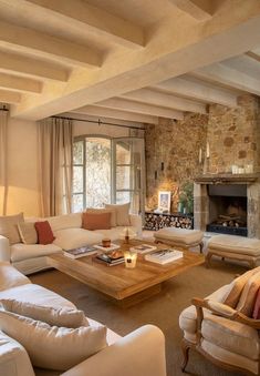 a living room filled with furniture and a fire place in the middle of a room