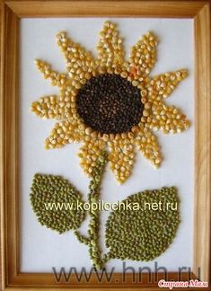 the beaded sunflower is in a wooden frame