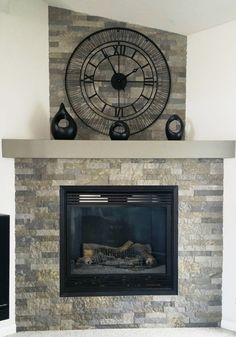 a fireplace with a large clock above it