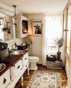 a bathroom with a rug, sink and toilet in it's centerpieces