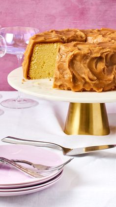 a cake sitting on top of a white plate next to a knife and fork,