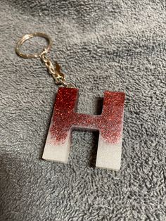 the letter h is painted with red and white glitters on it's side