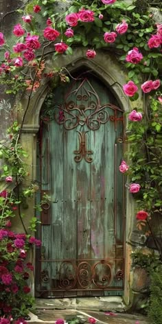 an old door with pink roses growing on the outside, and green foliage surrounding it