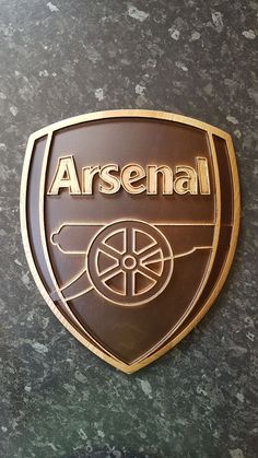 the logo for arsenal is shown on a wall in front of a granite counter top