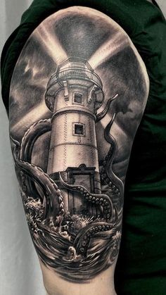 a man's arm with an octopus and lighthouse tattoo on it