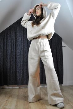 This is a super cool pair of modern tracksuit pants. Very flattering, trendy loose flared cut. Elasticated waist with inside drawstring. It has got a stitched crease for modern edgy look.  The color is very flattering to any complexion as it is glowy warm off white, natural.  The fabric is very high quality, made in Poland, with added hemp for its incredible properties (strength, absorbency, breathability, antimicrobial, sustainability). Here is a matching hoodie: https://www.etsy.com/listing/16 Beige Relaxed Fit Wide Leg Sweatpants, Beige Wide Leg Relaxed Fit Sweatpants, Relaxed Fit Flare Pants For Loungewear, Beige Wide-leg Relaxed Fit Sweatpants, Beige Relaxed Fit Wide-leg Sweatpants, Beige Wide-leg Sweatpants For Fall, Flare Cotton Pants For Streetwear, Trendy Cream Pants For Loungewear, Beige Wide Leg Sweatpants For Streetwear