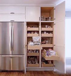 an organized pantry in the corner of a kitchen with stainless steel refrigerator and dishwasher