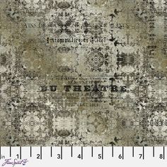 an old, faded rug with black and white designs on it's edges is shown