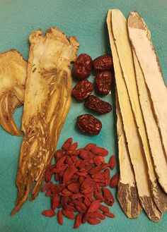 some dried fruits and vegetables on a blue table top with other items to make it look like they have been cut up