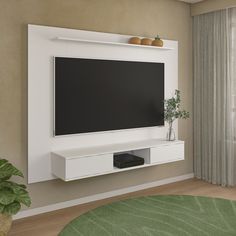 a flat screen tv mounted on a wall in a living room with a green rug