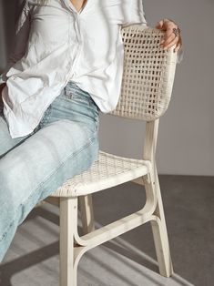 a woman sitting in a chair with her legs crossed