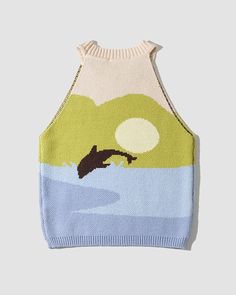 a sweater with an image of a bird flying over the ocean on it's back