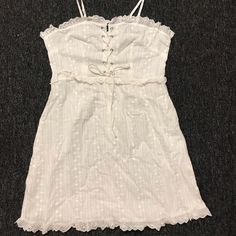 White, Sheer, Cotton, Summer Dress With Bustier Like Cinch At The Breast-Adjustable For Breast Size. Silver Eyelets. Shoulder Straps Are Ties And Adjustable. Nwot. Never Worn. Casual Strapped Mini Dress For Daywear, Casual Strappy Mini Dress For Daywear, White Cotton Dress With Drawstring, White Cotton Drawstring Dress, White Drawstring Dress For Day Out, Casual Mini Dress With Straps For Day Out, Casual White Dresses With Straps, White Mini Dress With Drawstring For Spring, Spring White Mini Dress With Drawstring