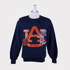 Vintage 90s Auburn Tigers (Auburn University) Football/Basketball NCAA Sweatshirt 💯 SATISFACTION AND AUTHENTICITY ⭐ MEASUREMENTS (when laid flat) Size on Tag: M Length: 68cm or 27 inches Armpit to armpit: 52cm or 20.5 inches ⭐ CONDITION 9/10 (Very good) Details: No holes Material: Cotton Color: Dark Blue Navy Brand: Russell Athletic 🔷 Please give us your phone no. together with address after you purchased. 🔷Please keep in mind that our items are vintage so they may show some signs of wear and Throwback Long Sleeve T-shirt For College, Throwback College Tops With Embroidered Logo, Throwback Logo Print Sweatshirt For Fall, Fall Throwback Logo Print Sweatshirt, Vintage Letter Print Sweatshirt For Fan Gear, Collegiate Winter T-shirt For Streetwear, Embroidered Logo Tops For Fall Streetwear, Collegiate Fall Sweatshirt For Streetwear, Retro Fan Gear Sweatshirt For Sports Season