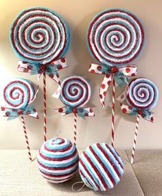 some lollipops are hanging on the wall next to two candy canes