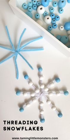 snowflakes made out of beads and thread in a box with text overlay reading threading snowflakes