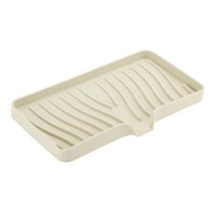 a white plastic tray with wavy lines on it