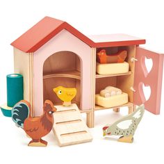 a wooden toy house with chickens and other toys