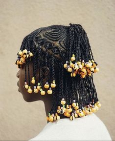 a mannequin head with beads and hair clips on it's back side