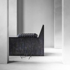 a black and white photo of a bench in an empty room