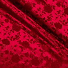 red fabric with flowers and leaves on it