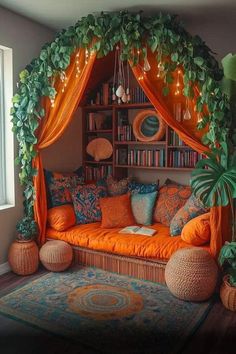 a living room with an orange couch, bookshelf and potted plants on the wall