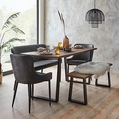 a dining table with two chairs and a bench