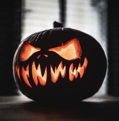 a carved pumpkin with scary teeth on it