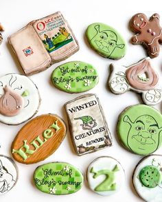 decorated cookies are arranged on a white surface