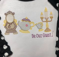 a t - shirt that says be our guest with two teapots and a candelabra