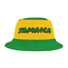 This Jamaica bucket hat is a patriotic national team fan hat for any sport with the Jamaican flag colors of green, yellow and black and the word "Jamaica" on a polyester bucket hat. Makes a perfect bucket hat for a national holiday, sporting event, summer hat, Jamaican party or Halloween party costume, Halloween costume, Jamaican flag hat, team Jamaica hat, football fan hat, game day hat, soccer fan hat, soccer fan apparel, Jamaica hat, Jamaican hat, Jamaica cap, Jamaica shirt accessories, Rasta Green Visor Hat With Letter Print, Yellow Sports Hat With Curved Brim, Yellow Cap For Sports Events, Green Snapback Hat With Letter Print For Outdoor, Casual Team-colored Hats With Letter Print, Green Visor Trucker Hat For Sports Events, Yellow Curved Brim Sports Hat, Yellow Sports Trucker Hat With Curved Brim, Green Cap For Game Day