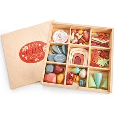 a wooden box filled with lots of different types of rocks and shapes on top of a white surface