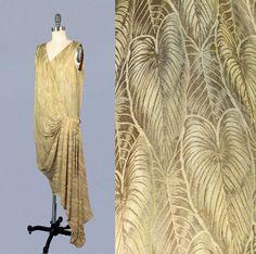 "Incredible 1920s metallic lame dress in a leaf motif. Dense, shimmering, metal fibers. Photos do not capture the beauty of this piece; the way it reflects and catches the light is amazing. Bright golden threads. Loose and easy fit. Asymmetrical, faux wrap silhouette, with v neck, perfect draping from pleated hip swag, and trailing hem. Attached sheer silk camisole lines the bodice. LAYAWAY is available for all items, please message me for details. Measurements: *no closures, slips over the head Recommended for a size S-M Bust: 35\" Dropped waist: 36\" Length: 45\" , 59\" Condition:  Great. Upon close inspection, I found one seam mend to shoulder, A few holes at hem of train, Some small faint spots of discoloration mostly at hip pleating. Also several pinhead sized spots wear fabric shows 1920s Dresses Formal, 20s Gown, 1920s Dress Pattern, Lamé Dress, 1920 Dress, 20s Dresses, Lame Dress, Art Deco Dress, 1920s Dress