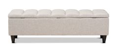 a white bench that is upholstered with some fabric on it and has black legs