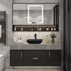 a modern bathroom with marble counter tops and black cabinetry, along with a white toilet