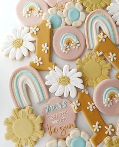 decorated cookies in the shape of numbers and flowers on a white surface with words that read, days first trip around the sun