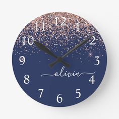 a blue clock with pink and gold glitters on it