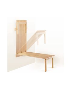 a wooden bench sitting next to a white wall with an open door on the side