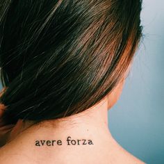 the back of a woman's neck with an inscription on it that reads, avere forza