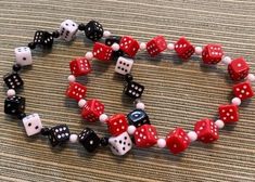 I have been sold out of my dice jewelry for a while and finally made time to make more and post it. This set includes 2 stretch bracelets and 2 pair of earrings that match. The bracelet fit about 7 1/2 = 8 inch wrists. If you like your bracelets loose, hanging on the top of your hand, then they will work for down to 7 inch wrists. One bracelet is red dice with white dots, other bracelet is black dice with white dots and white dice with black dots. There is a pair of earrings in red dice and a pair of earrings with black dice. Priced to sell. These are lightweight as all the dice are acrylic. Don't miss these.  Split up for gives if you want to stretch your money. Dice Jewelry, Red Dice, Themed Jewelry, Black Dots, Jewellery Sets, Stretch Bracelets, Matching Earrings, Jewelry Set, Jewelry Sets