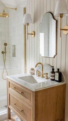 a bathroom with a sink, mirror and bathtub in it's corner before and after remodeling