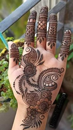 a hand with henna tattoos on it