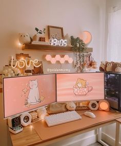 two computer monitors sitting on top of a desk next to a clock and other items