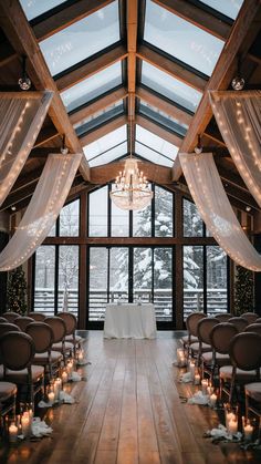 An indoor wedding with a large window looking out to a snowy winter scene. The inside is constructed with wood and it sets the scene of a warm and cozy wedding. Epic Wedding Venues, January Wedding Venues, Winter Chapel Wedding, Winter Italian Wedding, Mountain Wedding Winter, Winter Wonderland Weddings, Small December Wedding, Winter Wedding Elegant