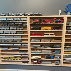 toy trains are lined up on shelves in a playroom for children to play with