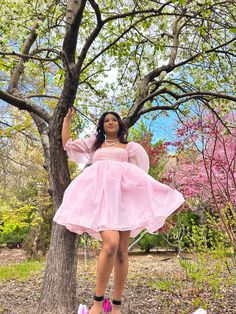 Pink Organza Babydoll Dress This is the babydoll dress for a dramatic, pink-loving princess. It's made entirely of high-quality sheer organza fabric, which makes it the puffiest, most dramatic babydoll dress in all of our collections! The skirt is made of three layers and the top is double-layered. Both the sleeves and top maintain their sheerness. All of the seams are inside the layers to prevent fraying and itchiness. The elastic at the bottom of the sleeve creates a ruffle effect at the elbow. It closes at the back with an invisible zipper. Model is 5'2" wearing a size small. Pink Bubble Hem Dress For Spring, Balletcore Puff Sleeve Party Dress, Spring Pink Dress With Sheer Bodice, Spring Princess Dress In Organza With Ruffles, Spring Princess Dress With Ruffles In Organza, Pink Tutu Dress For Prom In Spring, Pink Puff Sleeve Mini Dress For Prom, Pink Puff Sleeve Mini Dress For Wedding, Pink Babydoll Dress Wedding