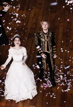 a bride and groom walking through confetti