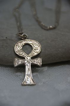 This is a superb piece of Egyptian jewellery and dates from c1970s. The pendant is a solid Silver Ankh (Egyptian Cross) also known as the key of life.  It is decorated with beautiful hieroglyphic symbols.  The pendant is also Silver.  Both items are stamped 925 (Silver).  The pendant measures:  3.1cm (including the bale)  by 1.7cm. The chain measures:  51cm. Vintage Ankh Metal Necklace, Vintage Ankh Necklace In Metal, Vintage Metal Ankh Necklace, Silver Ankh Necklace In Brass, Vintage Silver Ankh Jewelry, Antique Ankh Collectible Jewelry, Vintage Engraved Ankh Jewelry, Ankh Egyptian, Egyptian Jewellery