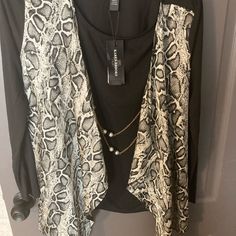 Nwt Snakeskin Cardigan With Attached Black Tank Underneath. The Attached Necklace Can Be Removed. The Snakeskin Print Is Made Up Of Different Shades Of Grey & Black. The Hem Is A Little Asymmetrical In The Front. Very Cute Cardigan For The Fall! Please Ask Questions If You Have Any! Feel Free To Make Me An Offer! Bundle With Other Items For Discounts! I Cleaned Out My Closet & Need To Get Rid Of Some Things Asap!! Black Open Front Top For Layering, Black Open Front Top For Work, Black Open Front Tops For Work, Cute Cardigans, Snakeskin Print, Me Clean, Black Tank, Shades Of Grey, Snake Skin